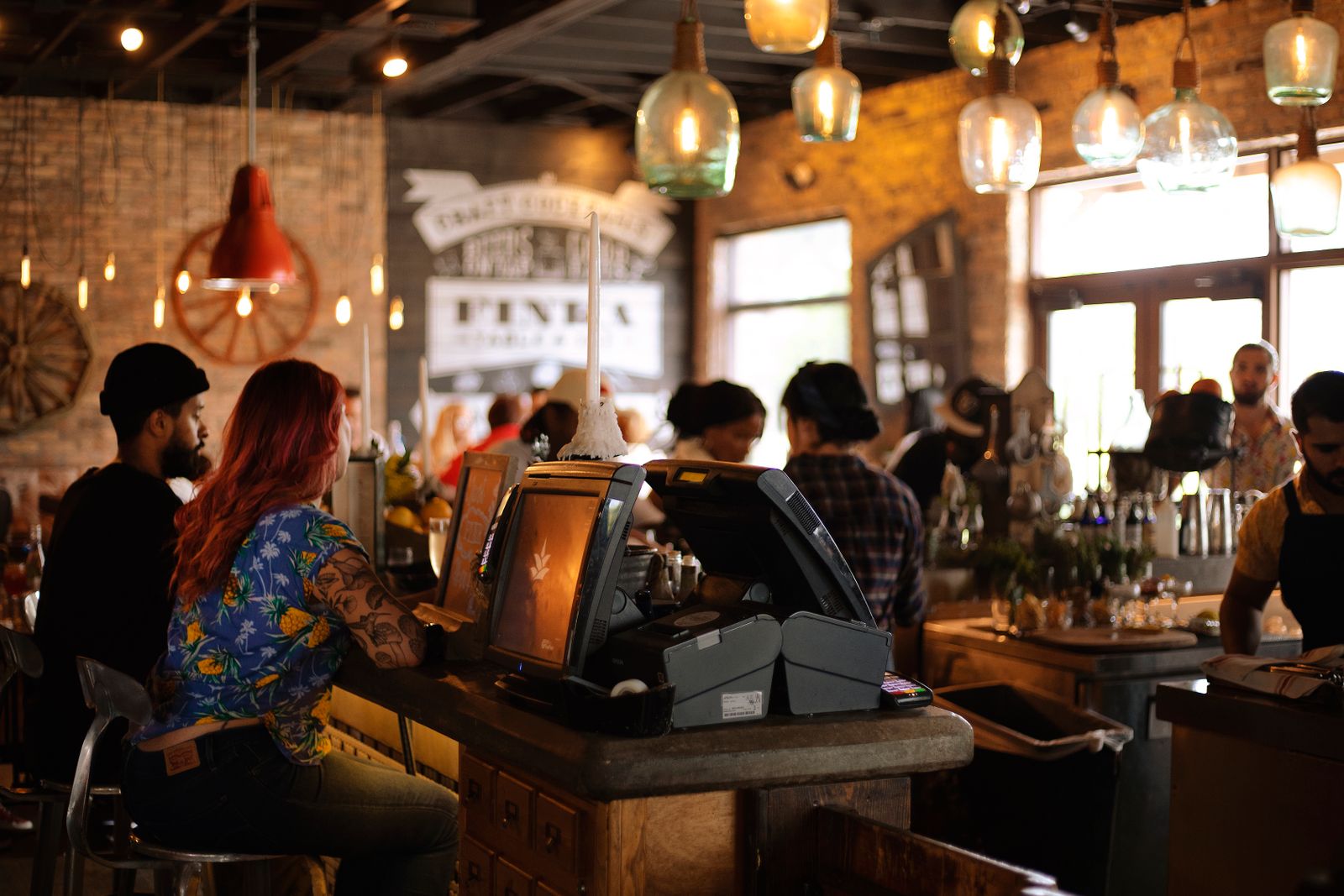 A warm cafe with customers, a service counter and a team at work